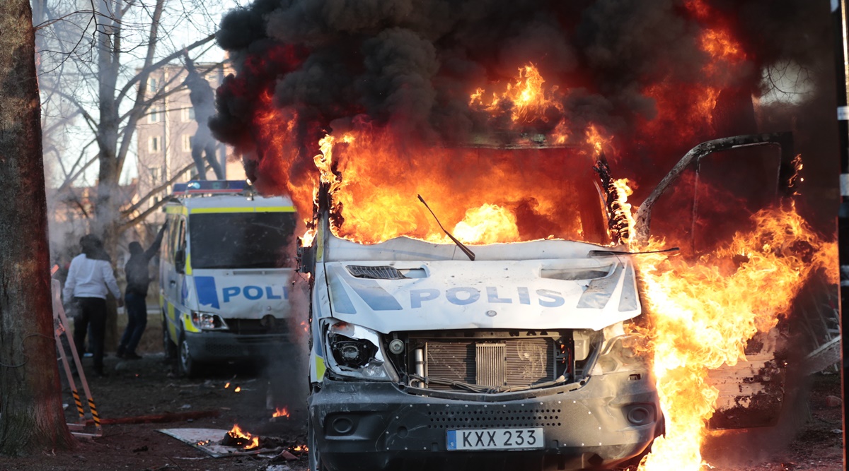Protesters set fire to a police bus in the park Sveaparken in Orebro, Sweden. (AP)