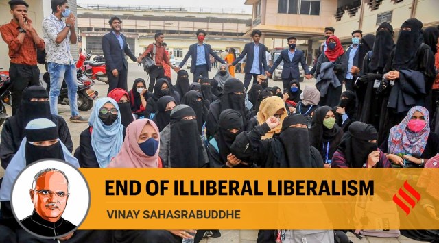 Students sit in protest after being denied entry while wearing hijab, outside a college campus, in Chikmagalur. (PTI)
