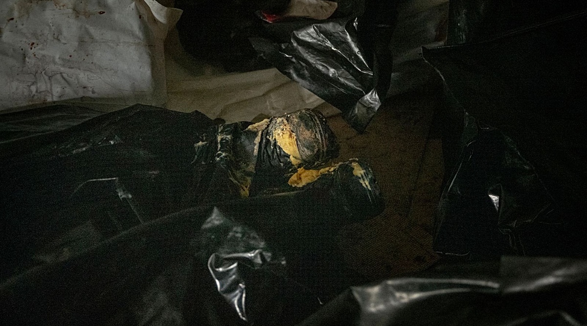The boots of one the 62 Russian soldiers’ bodies stick out from a bag, in a refrigerated train car on the outskirts of Kharkiv, Ukraine, May 29, 2022. (New York Times)