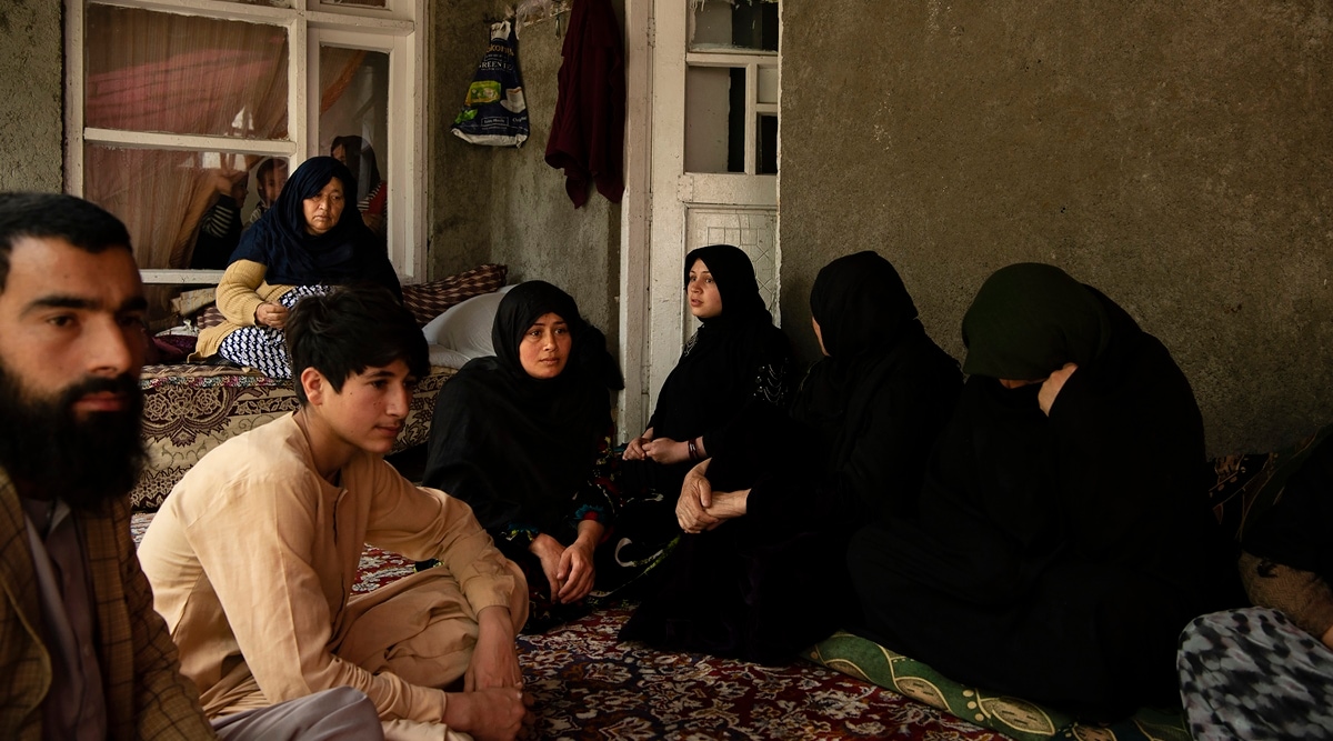 Relatives mourn Mohammad Hussein, who was killed in one of two explosions at a boys' school in Kabul, the Afghan capital, April 27, 2022. (Kiana Hayeri/The New York Times)