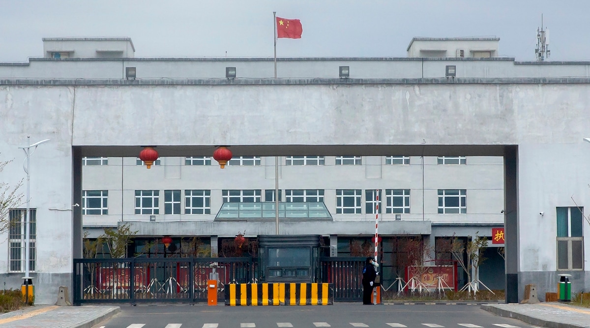 Police officers stand at the outer entrance of the Urumqi No. 3 Detention Centre in Dabancheng in western China's Xinjiang Uyghur Autonomous Region on April 23, 2021. (AP)