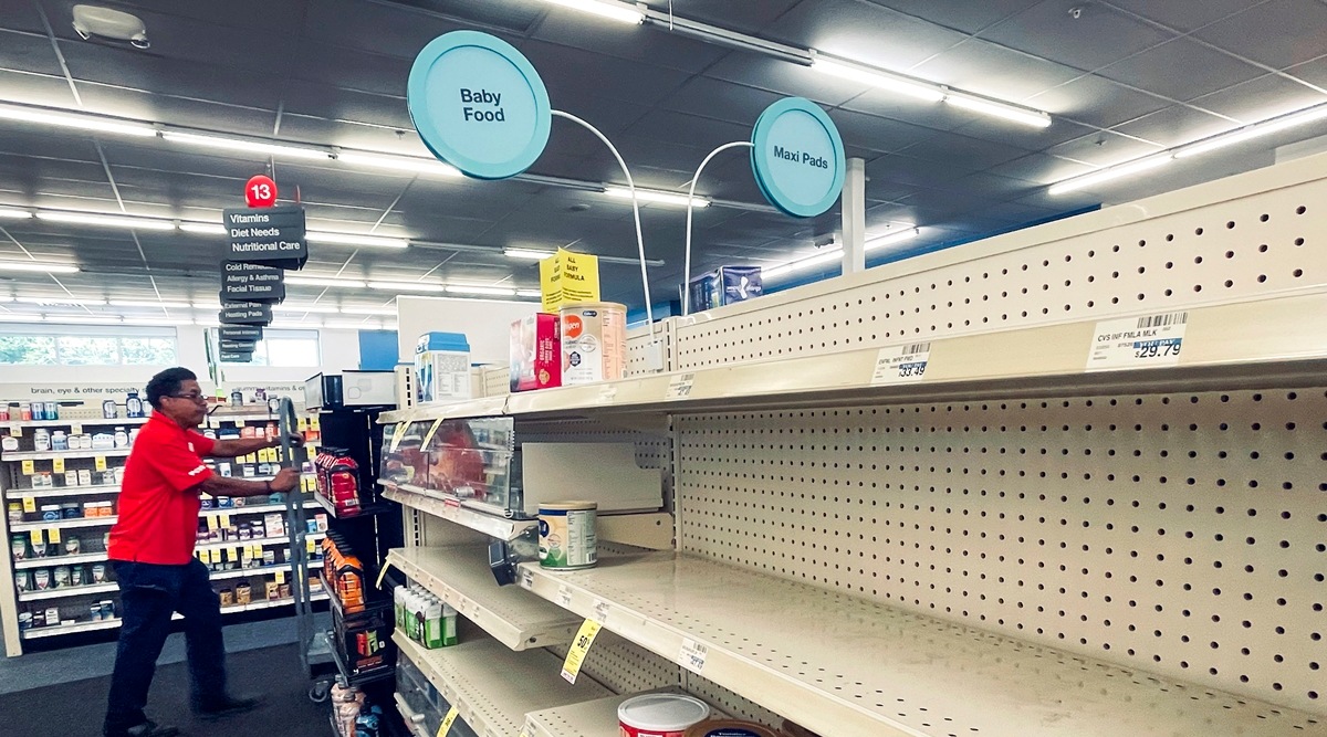 An employee walks near empty shelves where baby formula would normally be located at a CVS in New Orleans on Monday, May 16, 2022. (AP)
