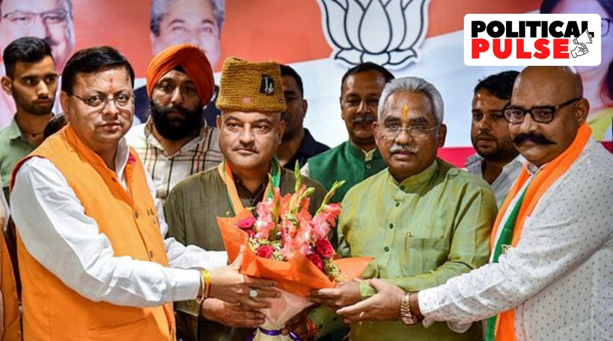 Uttarakhand Chief Minister Pushkar Singh Dhami and State BJP President Madan Kaushik present a bouquet to former AAP leader Colonel Ajay Kothiyal (retd) after he joined BJP, in Dehradun, Tuesday, May 24, 2022. (PTI)
