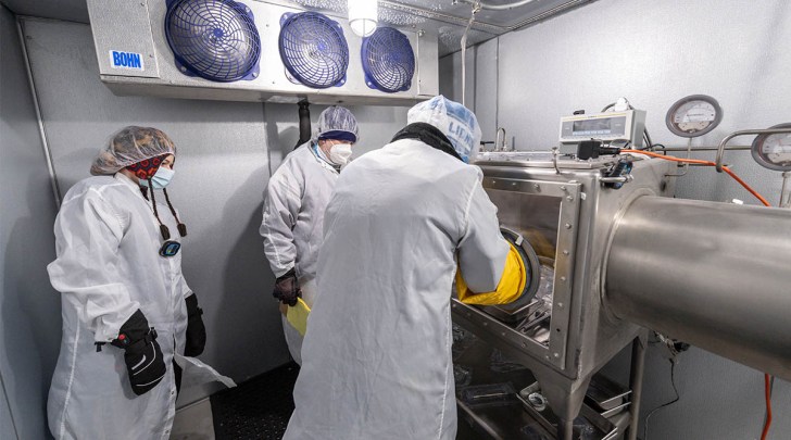 Scientists preparing apollo 17 moon samples inside a walk-in freezer.