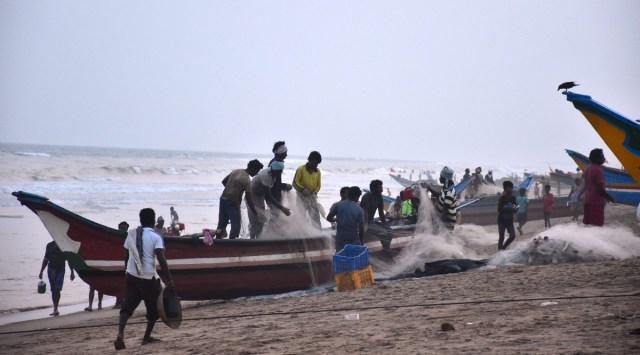 Fishermen unload their catches and park their boats on the shore amid cyclone Asani warning. (PTI)