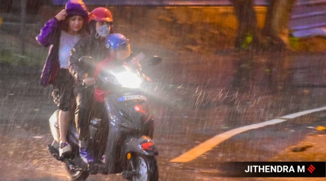 Vehicles ply on a road during heavy rain in Bengaluru on Sunday. (Express Photo by Jithendra M)