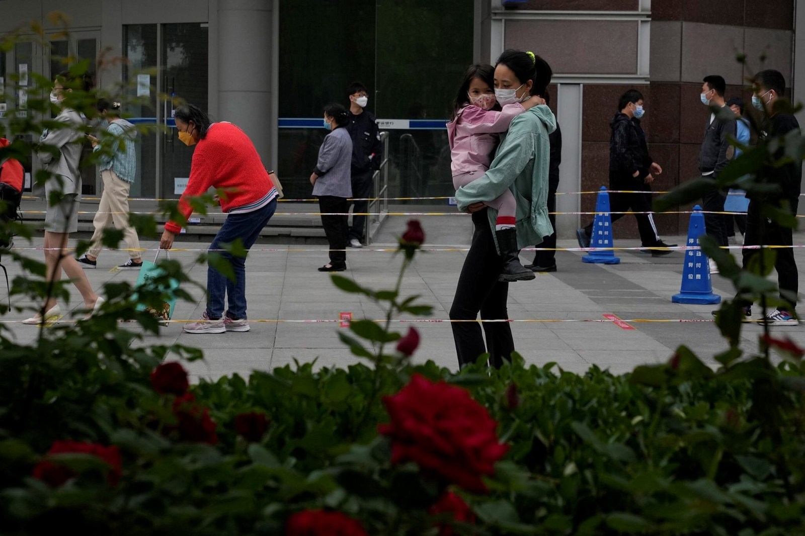 Residents wearing masks line up for mass Covid testing in Beijing on Tuesday. China's capital began another round of three days of mass testing for millions of its residents Tuesday in a bid to prevent an outbreak from growing to Shanghai proportions. (AP)