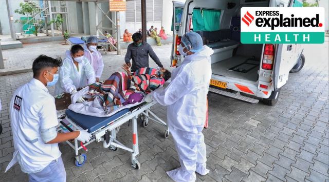 A Covid-19 infected patient is shifted at Civil hospital in Asarwa. (Express Photo: Nirmal Harindran, File)
