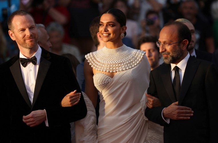 Jury member Joachim Trier, from left, Deepika Padukone and Asghar Farhadi pose for photographers