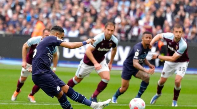 Manchester City's Riyad Mahrez takes a penalty during the English Premier League soccer match between West Ham United and Manchester City at London stadium in London, Sunday, May 15, 2022. (AP Photo/Kirsty Wigglesworth)