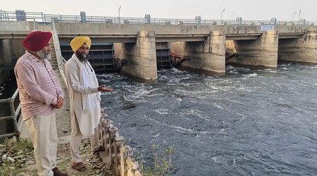 Gurpreet Singh Chandbaja showing black water being released into Ferozpur Feeder from Harike Headworks. (Express Photo)