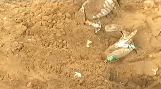On the morning of May 15, based on a tip-off, a team of police officials attached to the D-5 Marina police station visited the area behind the Kannagi statue and found illicit liquor hidden under the sand. (Photo: Screengrab/sourced)