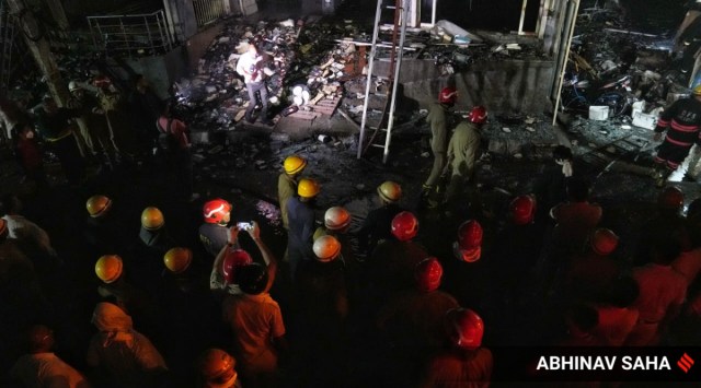 Firefighters try to douse a fire which broke out in a building at Mundka, in West Delhi, Friday, May 13, 2022.