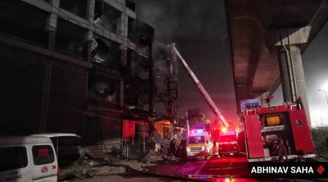Firefighters try to douse a fire which broke out in a building at Mundka, in West Delhi, Friday, May 13, 2022.