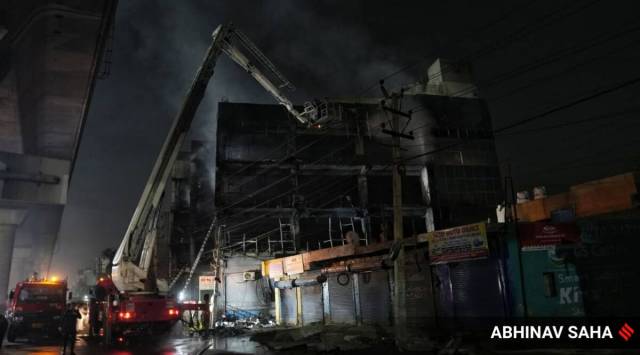 Firefighters try to douse a fire which broke out in a building at Mundka, in West Delhi, Friday, May 13, 2022. (Express Photo)