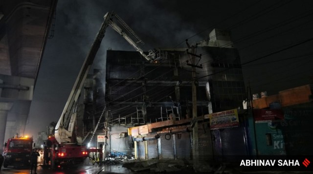  Firefighters try to douse a fire which broke out in a building at Mundka, in West Delhi, Friday, May 13, 2022