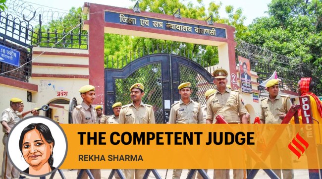Police personnel stand guard on the day of the hearing of the Gyanvapi Masjid-Shringar Gauri Temple case, outside the Varanasi District Court, Tuesday. (PTI)