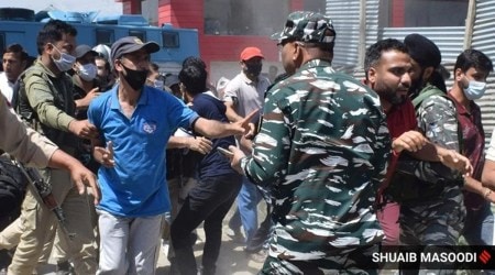 As protestors put up a blockade on the Srinagar-Budgam highway, the police try to disperse them. (Express photo by Shuaib Masoodi, file)