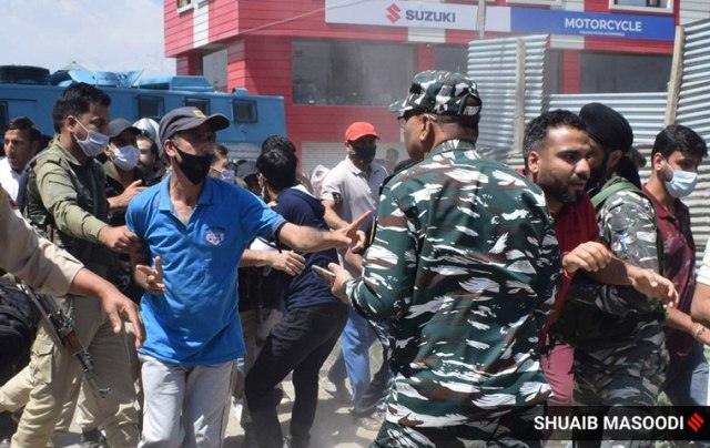 As protestors put up a blockade on the Srinagar-Budgam highway, the police arrived to disperse them. (Express Photo by Shuaib Masoodi)