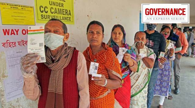 Citizens show their identification cards as they wait to cast their votes. (PTI Photo)