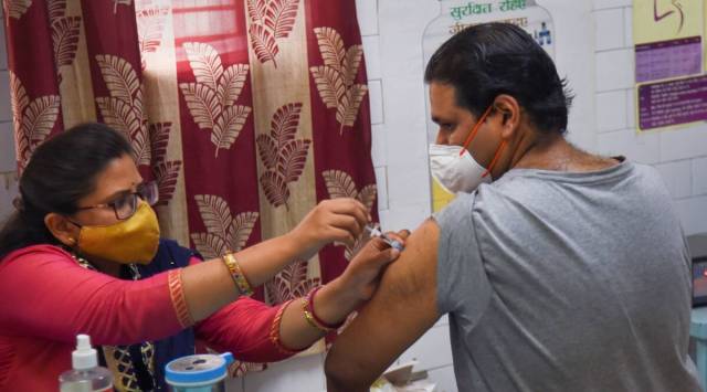 A healthcare worker administers a dose of the Covid-19 preventive vaccine to a man at a vaccination centre, in New Delhi. (PTI)