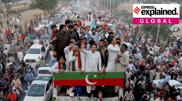 Ousted Pakistani Prime Minister Imran Khan gestures as he travels on a vehicle to lead a protest march in Islamabad, Thursday. (REUTERS)
