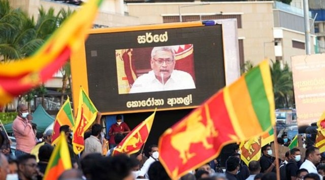 Sri Lankans protest demanding president Gotabaya Rajapaksa resign as his speech is projected on a giant screen at the ongoing protest site outside president's office in Colombo, Sri Lanka, Friday, April 29, 2022. (AP)