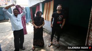 Kolkata Knight Riders and Uttar Pradesh all-rounder Rinku Singh with his parents at the two-room accommodation inside the gas cylinder stockyard. (Express Photo: Gajendra Yadav)