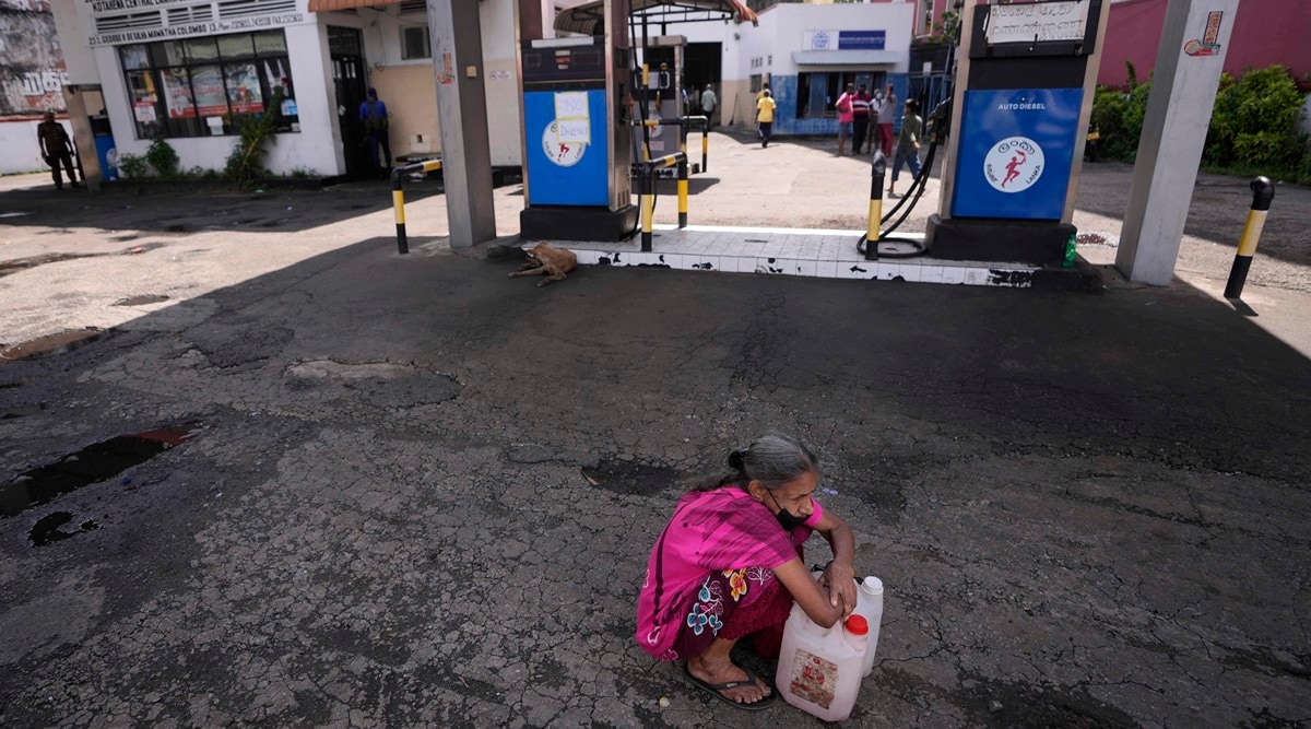 A Sri Lankan woman waits in a deserted gas station. (AP Photo/Eranga Jayawardena)