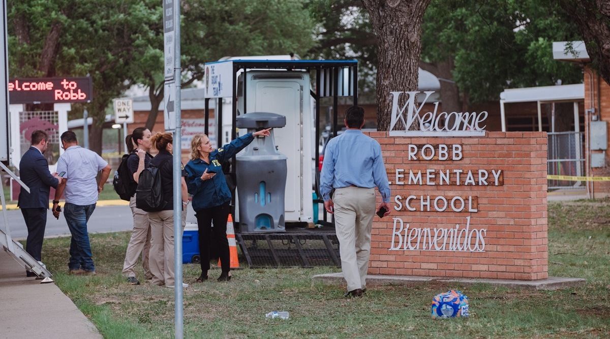 Law enforcement outside Robb Elementary School in Uvalde, Texas, where a gunman killed at least 18 children and a teacher on May 24, 2022. (Christopher Lee/The New York Times)