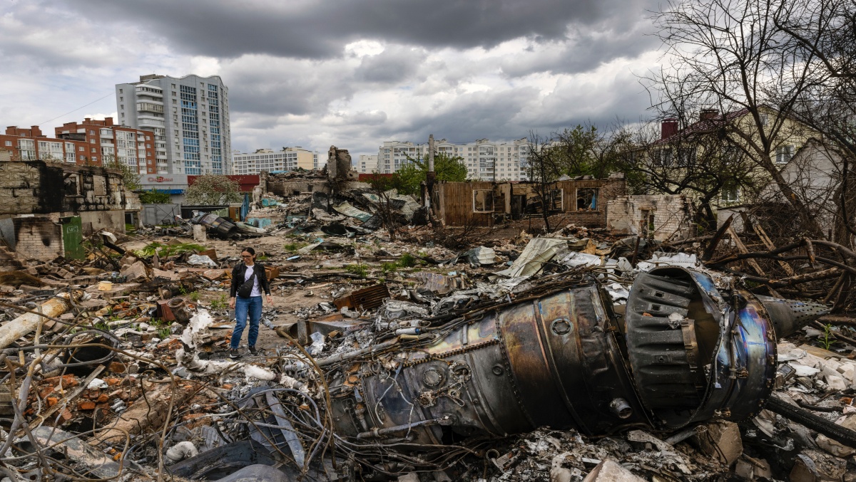 Yulia Hrebnyeva on May 14, 2022, amid the wreckage of a Russian warplane that crashed into her family’s home in Chernihiv, Ukraine, in March. (David Guttenfelder/The New York Times)