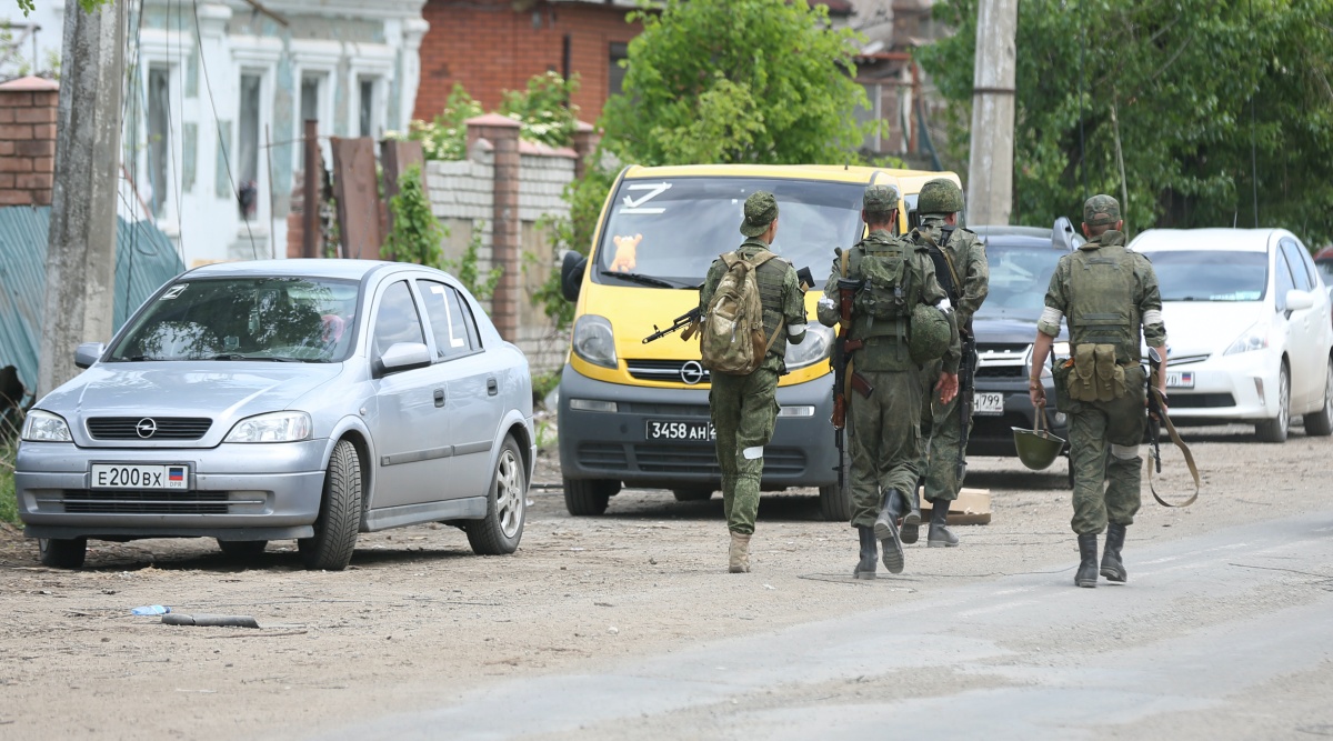 Servicemen of Donetsk People's Republic militia walk in Mariupol, in territory under the government of the Donetsk People's Republic, eastern Ukraine, Tuesday, May 17, 2022. (AP Photo)