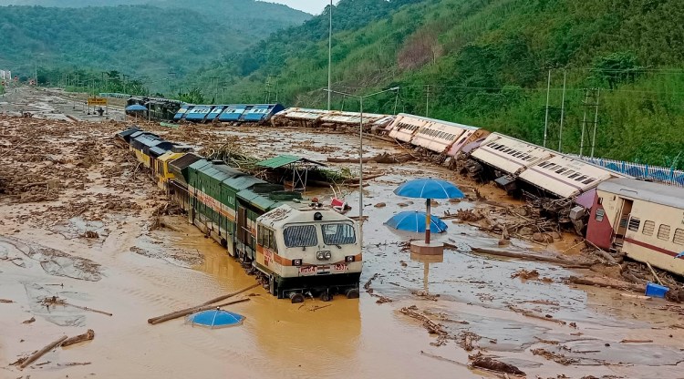 Train coaches are seen toppled over following mudslides triggered by heavy rains at New Haflong railway station on the Lumding-Silchar route at Dima Hasao district in Assam. (AP)