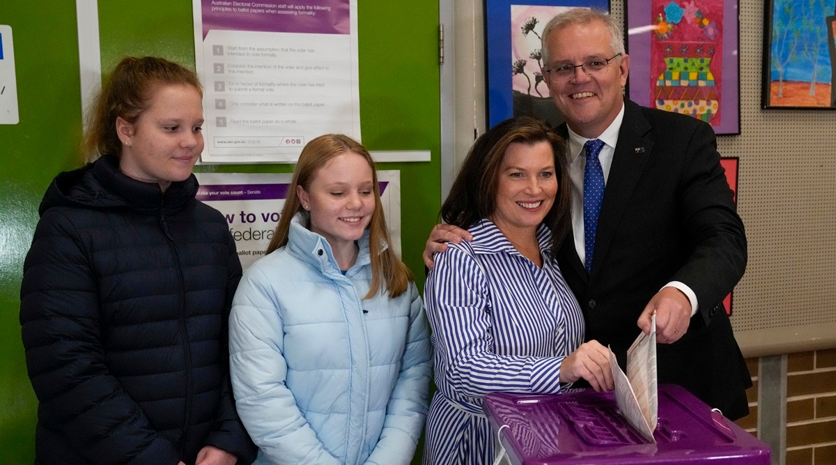 Australian Prime Minister Scott Morrison his wife Jenny cast their votes at a polling booth in his electorate of Cook as their daughters Lily and Abbey watch in Sydney, Australia, May 21, 2022. (AP)