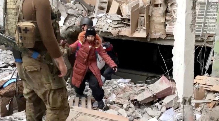 A child emerges from the Azovstal steel plant during UN-led evacuations, after nearly two months of siege warfare on the city by Russia during its invasion, in Mariupol, Ukraine in this still image from handout video released May 1, 2022. (David Arakhamia/Azov Regiment/Handout via Reuters)