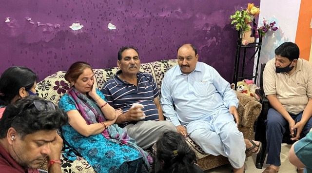 Rahul's father Bitta Ji Bhat (centre wearing blue shirt) sitting in shock along with his sister and other relatives at home in Durga Nagar, Jammu, on Thursday. (Photo: Arun Sharma)