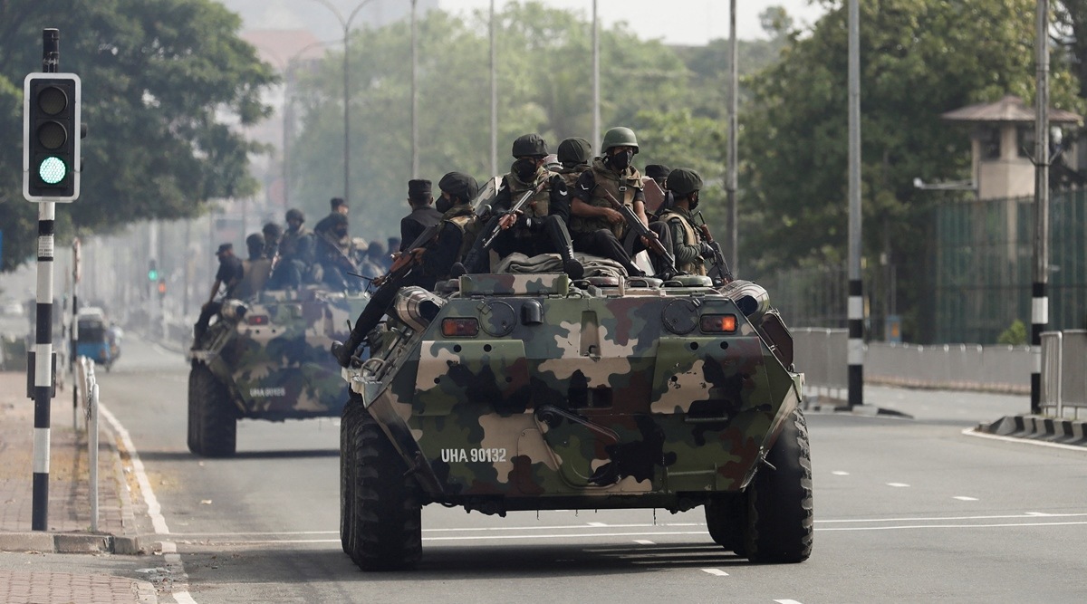 Army members travel on armoured cars on the main road in Colombo, Sri Lanka, May 11, 2022. (Reuters)