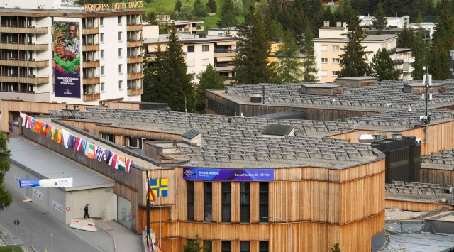 People walk in front of the congress center where the World Economic Forum take will place, on the eve of the event in Davos. (AP)