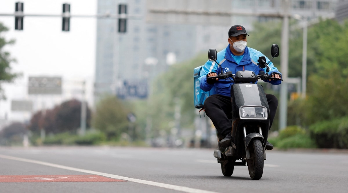 A delivery driver rides an electric scooter. (File photo via Reuters)