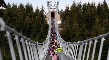 People walk across the newly-built world's longest suspension bridge after its official opening in the mountain resort of Dolni Morava, Czech Republic (Source: Reuters)