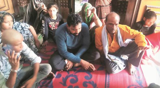The family of Rajkumar alias  Raju Chauhan at Bisana village in Hathras on Thursday. (Express Photo)