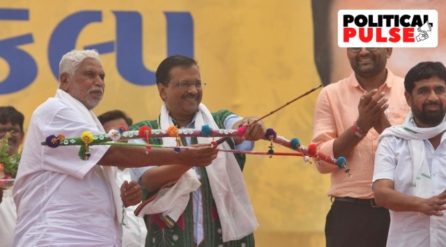 Bharatiya Tribal Party (BTP) leader Chhotubhai Vasava and Delhi Chief Minister Arvind Kejriwal at Chanderiya village in south Gujarat's Bharuch district on Sunday. (Express Photo by Bhupendar Rana)
