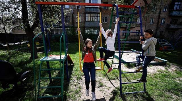 Ulyana Nalapko, 11, along with her sister Melania, 8, and their friend Mykyta Rubanik, 6, play at a playground, amid the Russian invasion of Ukraine, in Bucha, Kyiv region. (Reuters)