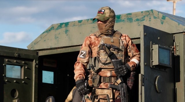 A service member of pro-Russian troops stands guard before the expected evacuation of wounded Ukrainian soldiers from the besieged Azovstal steel mill in the course of Ukraine-Russia conflict in Mariupol, Ukraine May 16, 2022. (Reuters)