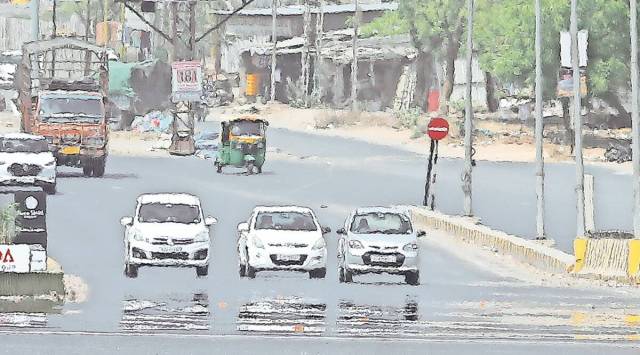A mirage appears on SP Ring road in Ahmedabad as temperature soars across the state. (Express photo by Nirmal Harindran)