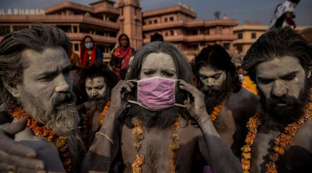 This photo by Reuters photographer Danish Siddiqui, provided by Columbia University, shows a 'Naga Sadhu' placing a mask across his face at the Kumbh Mela festival. Reuters photographers Adnan Abidi, Sanna Irshad Mattoo, Amit Dave and the late Danish Siddiqui of Reuters were awarded the 2022 Pulitzer Price for Feature Photography. (AP)