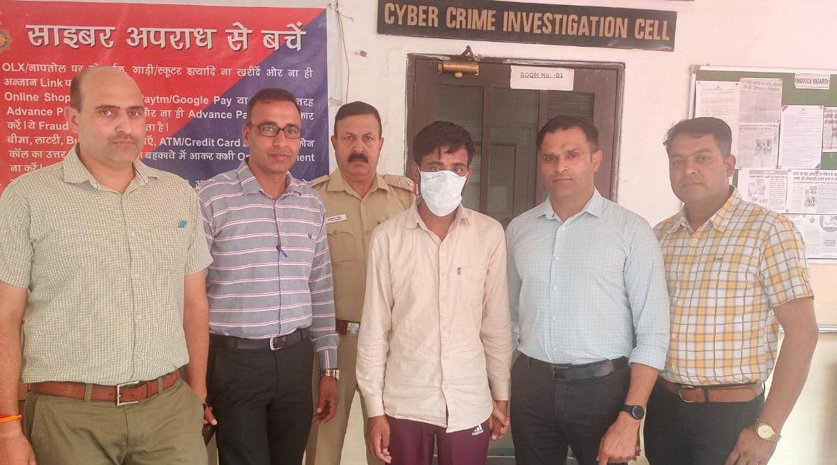 Accused Vikas alias Vicky (wearing mask) in the custody of UT Cyber Crime Cell. (Express)