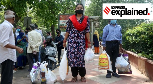 People wait to collect ration in New Delhi. (Express Photo: Amit Mehra, File)