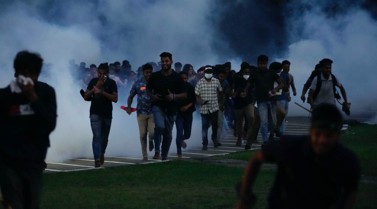 Sri Lankan students of Inter university students' federation run in the midst of a tear gas cloud during a protest outside parliament in Colombo, Sri Lanka, Thursday, May 5, 2022. Sri LankaÄôs beleaguered government won a key vote in Parliament on Thursday as a ruling coalition-backed candidate was elected deputy speaker, despite growing public pressure on the government amid the worst economic crisis in decades. (AP/PTI Photo)