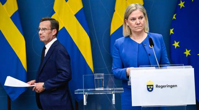 Sweden's Prime Minister Magdalena Andersson, right, and the Moderate Party's leader Ulf Kristersson give a news conference in Stockholm, Sweden, Monday, May 16, 2022. (Henrik Montgomery/TT News Agency via AP)